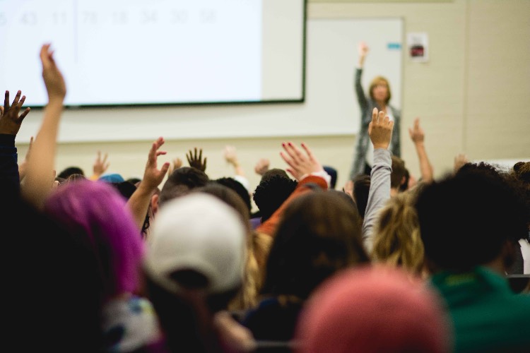 Hands raised during classroom presentation