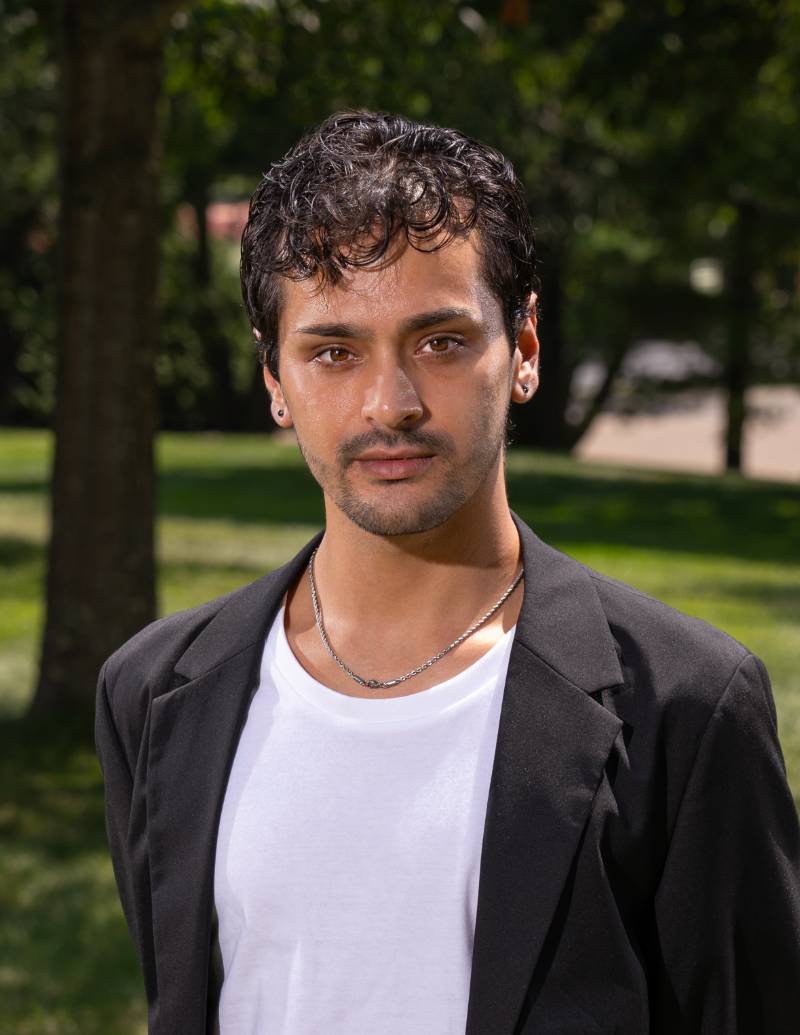 Dr. Lomeli headshot, wearing black jacket and a white t-shirt