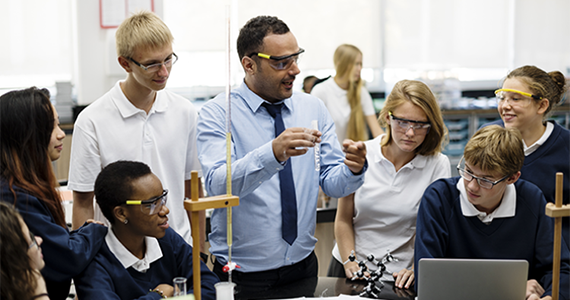 Science teacher demonstrating an experiment to students.