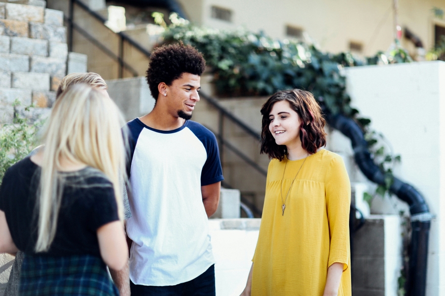 students stand around and smile together