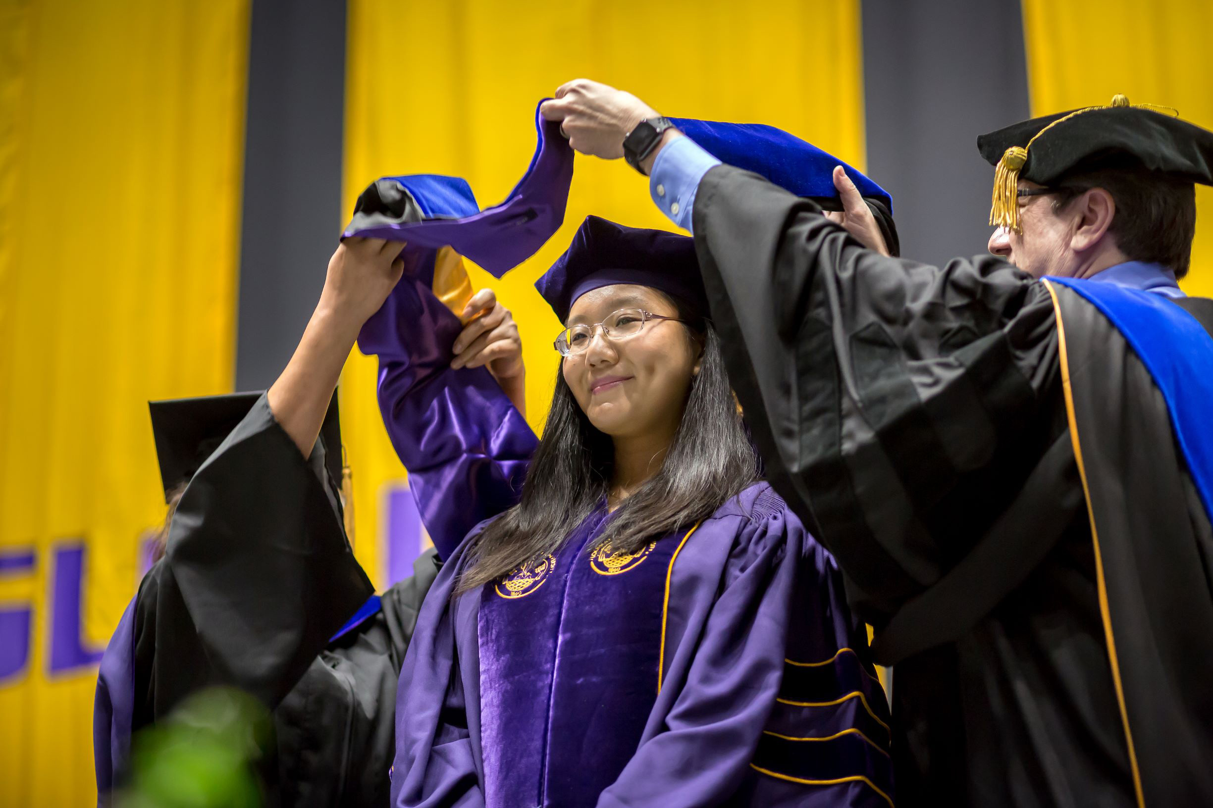 Woman Phd Graduate getting hooded