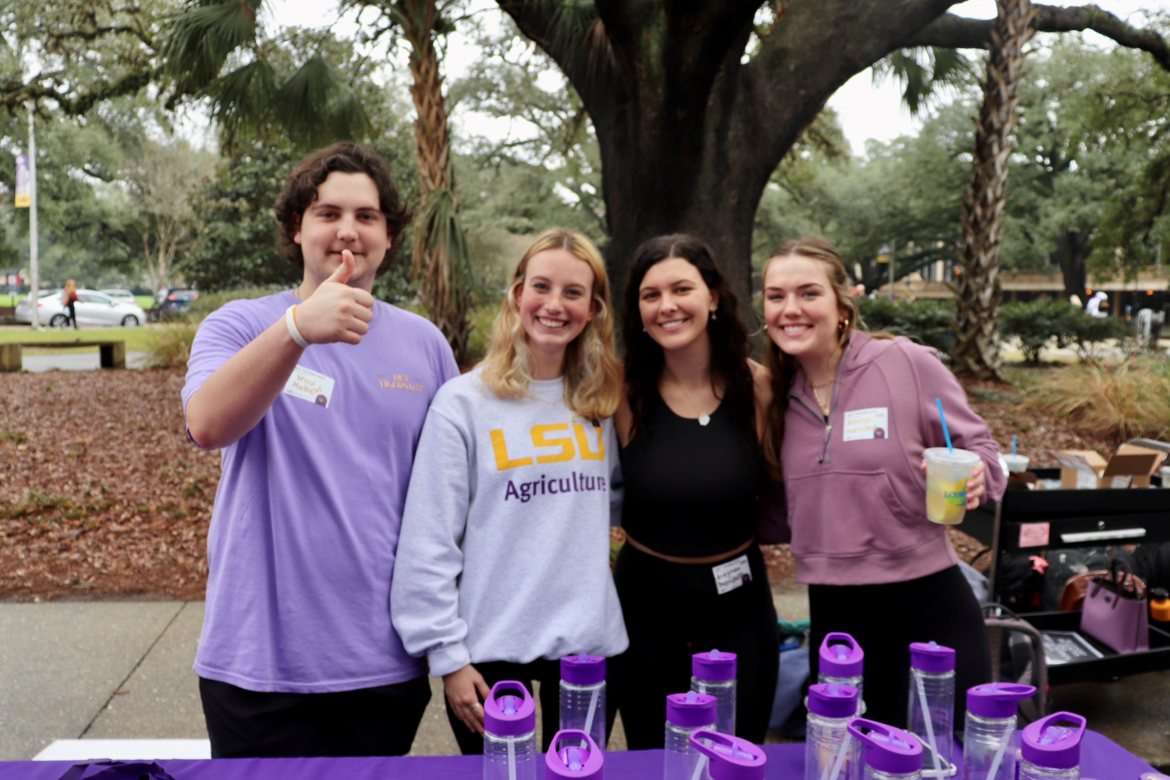 college council members smile behind a table sit