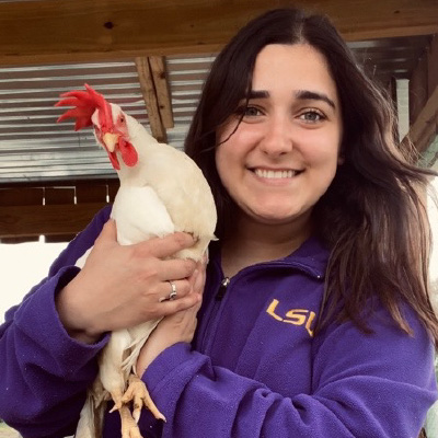 Blake poses with a chicken. 